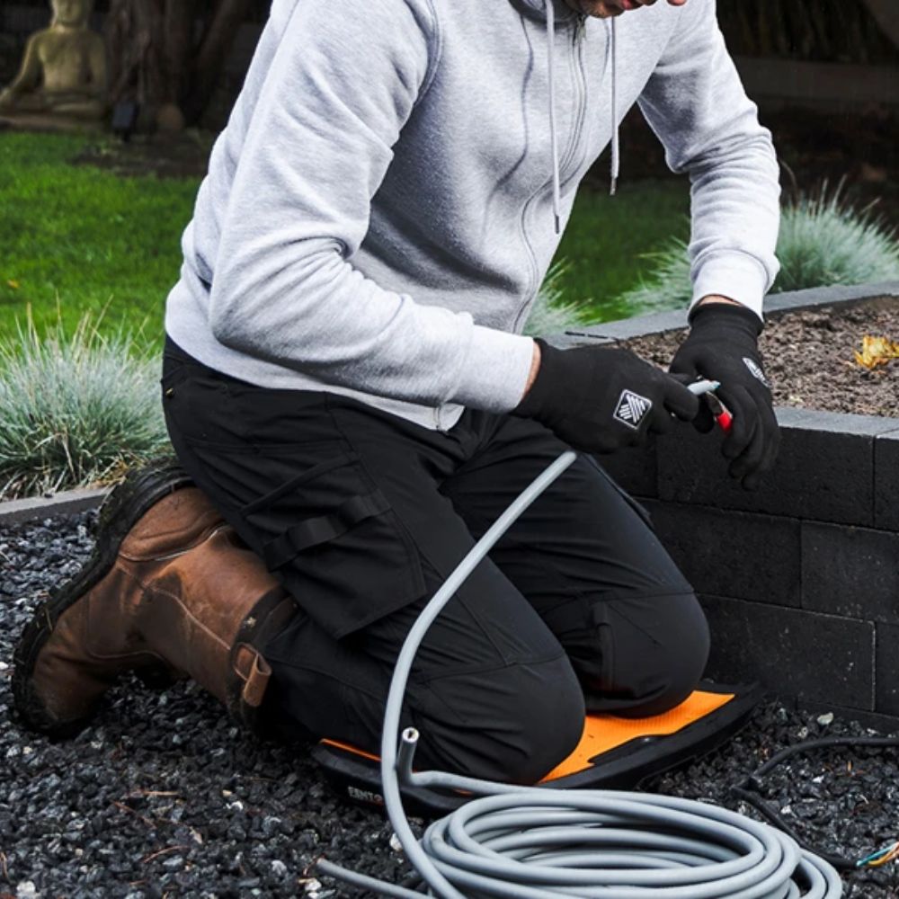 Homeowner kneeling on FENTO BOARD M2 on concrete slab