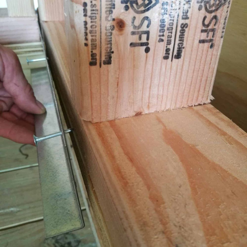 Installer fitting Rapid Recess L Bracket in stud wall