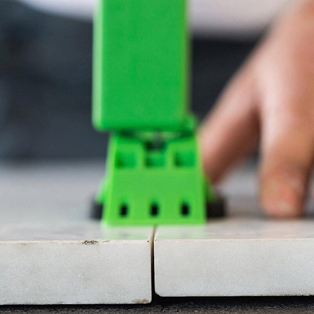 MLT installation tool tensioning reusable cap along a tile joint